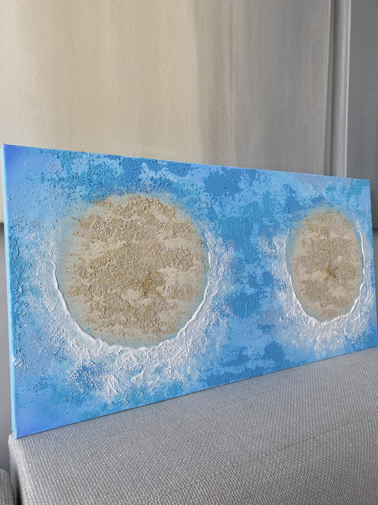 Angled view of the beach-inspired painting with vivid ocean blue tones and textured sandy islands.