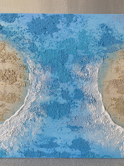 Detailed view of the textured blue wave flowing between two sandy islands in the luxury canvas artwork.